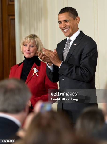 President Barack Obama, right, applauds Lilly Ledbetter, left, a former factory worker for Goodyear Tire & Rubber Co., before signing the Lilly...