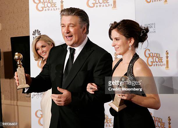 Actors Alec Baldwin, left, and Tina Fey hold their awards for their work in "30 Rock" at the 66th Annual Golden Globes Awards in Beverly Hills,...