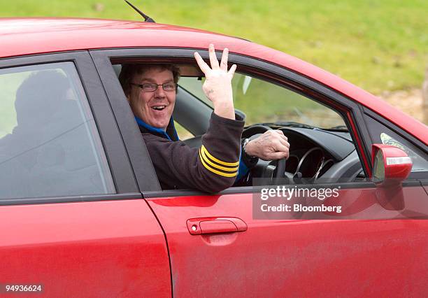 Member of the Honda workforce holds up four fingers, which signfy the number of months the plant will be shut, in Swindon, U.K., on Friday, Jan. 30,...