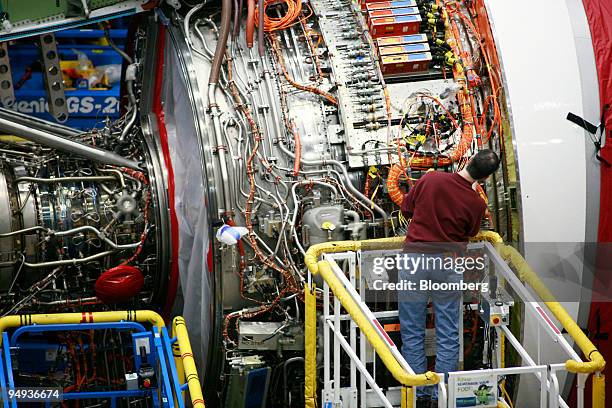 An employee works on an engine on the assembly line of the Boeing 787 Dreamliner at the Boeing Co. Manufacturing plant in Everett, Washington, U.S.,...