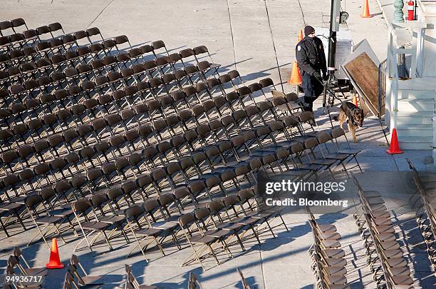 Capitol Hill police officer leads a dog through the seating area set up outside the U.S. Capitol for the inauguration of President-elect Barack Obama...