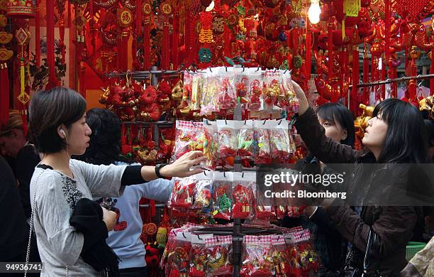 Shoppers browse among decorations and cards on sale at a Chinese New Year market in Hong Kong, China, on Wednesday, Jan. 21, 2009. According to the...