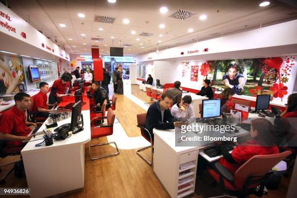 Vodafone employees sit with customers at the Vodafone store in Budapest, Hungary, on Saturday, Jan. 31, 2009. Vodafone Group Plc , the world's...