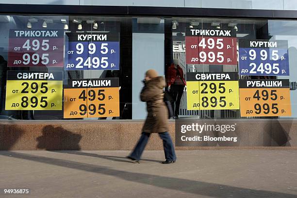 Pedestrian passes a clothing shop advertising its prices in Moscow, Russia, on Monday, Feb. 2, 2009. Russia's ruble weakened beyond the central...