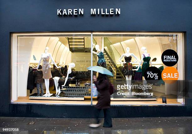 Pedestrian walks past a Karen Millen clothing store in Richmond, London, U.K., on Monday, Jan. 12, 2009. Retail sales had the worst December in 14...