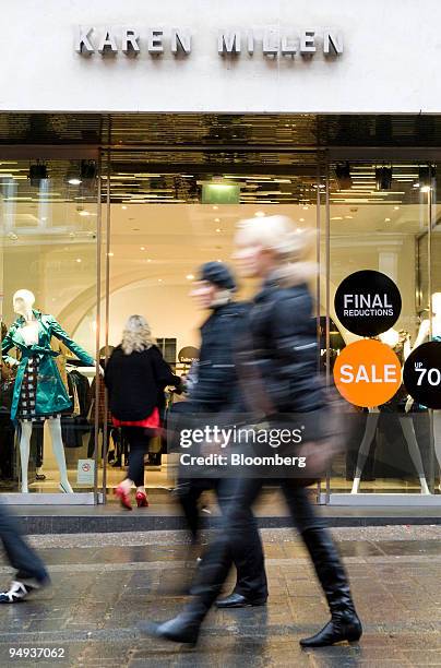 Pedestrians walk past a Karen Millen clothing store in Covent Garden, London, U.K., on Monday, Jan. 12, 2009. The British economy will shrink until...