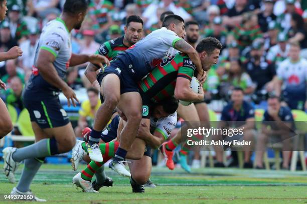 Sam Burgess of the Rabbitohs is tackled by the Raiders defence during the round seven NRL match between the South Sydney Rabbitohs and the Canberra...