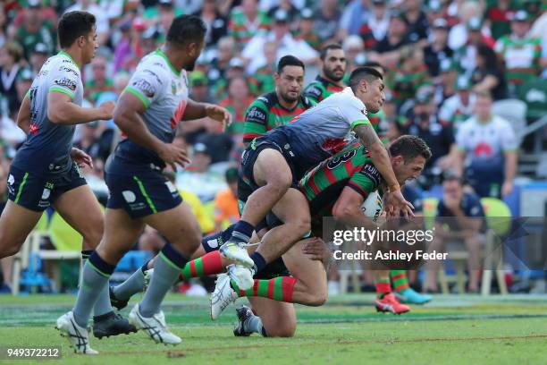 Sam Burgess of the Rabbitohs is tackled by the Raiders defence during the round seven NRL match between the South Sydney Rabbitohs and the Canberra...