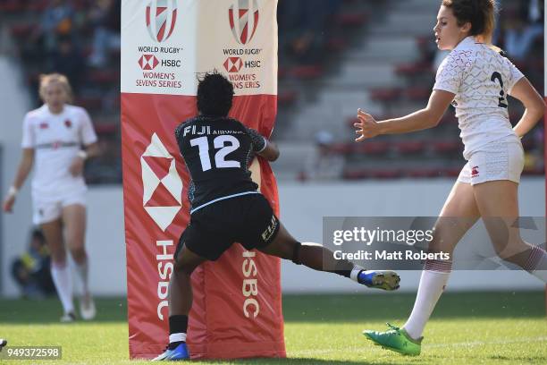 Tima Ravisa of Fiji is pushed into the goal post by Abbie Brown of England on day one of the HSBC Women's Rugby Sevens Kitakyushu Pool match between...