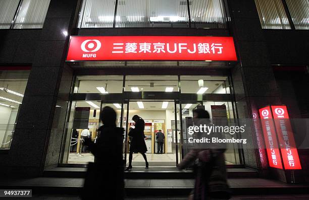 Pedestrians walk past a Bank of Tokyo Mitsubishi UFJ branch in Tokyo, Japan, on Thursday, Jan. 15, 2009. Mitsubishi UFJ Financial Group Inc., Japan's...