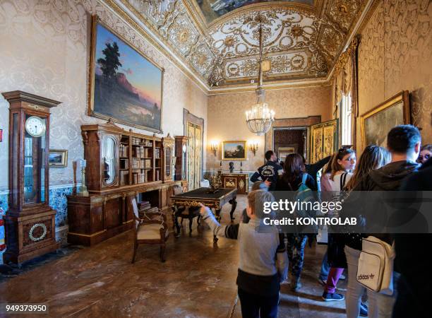 Visitors inside a room of the royal palace of Naples, in Campania, in southern Italy.