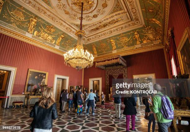 Visitors inside a room of the royal palace of Naples, in Campania, in southern Italy.
