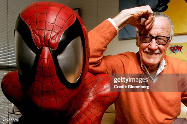 Stan Lee, founder of Marvel Entertainment Inc., poses next to a Spider-Man model in his office in Beverly Hills, California, U.S., in this file photo...