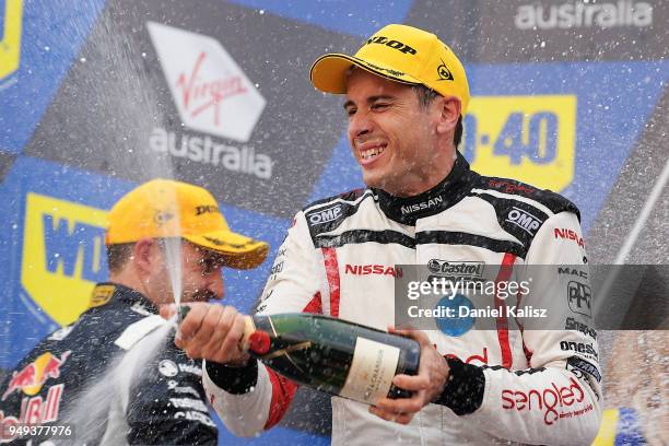 Rick Kelly driver of the Nissan Motorsport Nissan Altima celebrates on the podium after finishing third in his 500th race during the Supercars...