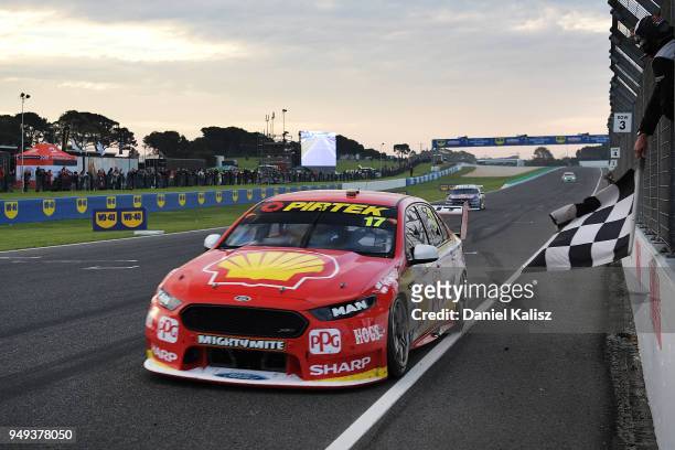 Race winner Scott McLaughlin drives the Shell V-Power Racing Team Ford Falcon FGX takes the chequered flag during the Supercars Phillip Island 500 at...