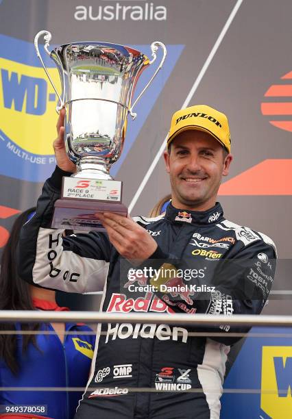 2nd place Jamie Whincup driver of the Red Bull Holden Racing Team Holden Commodore ZB celebrates on the podium during the Supercars Phillip Island...