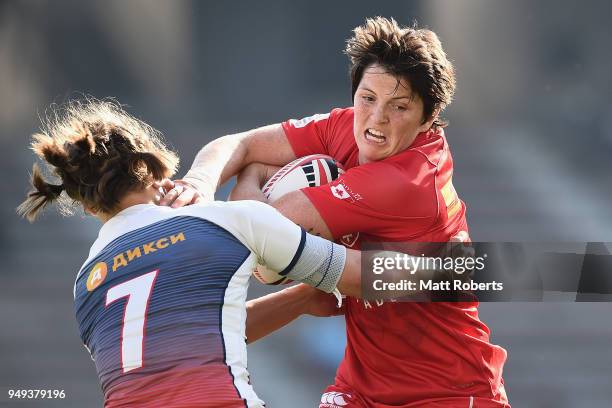 Brittany Benn of Canada is tackled by Kristina Seredina of Russia on day one of the HSBC Women's Rugby Sevens Kitakyushu Pool match between Canada...