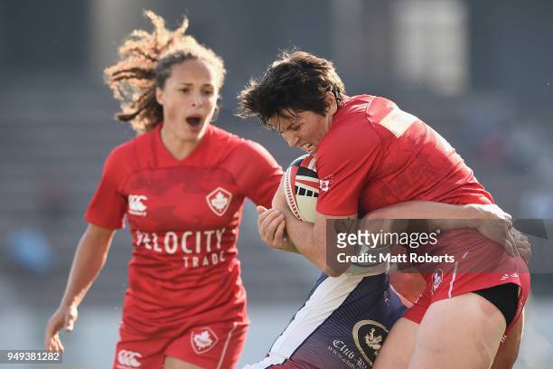 Brittany Benn of Canada is tackled by Kristina Seredina of Russia on day one of the HSBC Women's Rugby Sevens Kitakyushu Pool match between Canada...