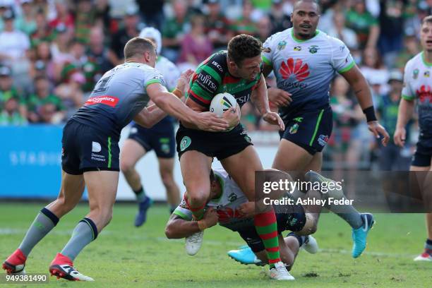 Sam Burgess of the Rabbitohs is tackled by the Raiders defence during the round seven NRL match between the South Sydney Rabbitohs and the Canberra...