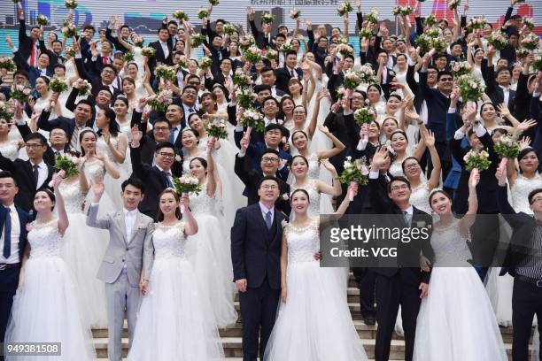 Newly-wed couples attend a group wedding ceremony before International Workers' Day on April 21, 2018 in Hangzhou, Zhejiang Province of China. 108...