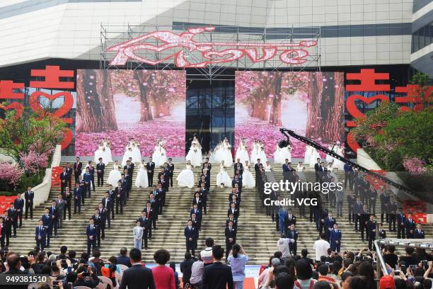 Newly-wed couples attend a group wedding ceremony before International Workers' Day on April 21, 2018 in Hangzhou, Zhejiang Province of China. 108...