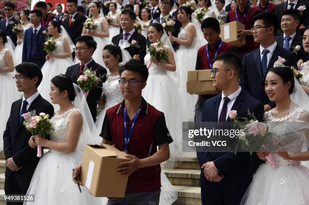 Newly-wed couples attend a group wedding ceremony before International Workers' Day on April 21, 2018 in Hangzhou, Zhejiang Province of China. 108...