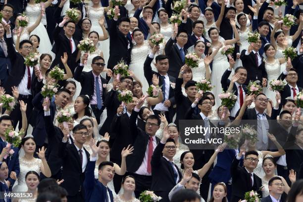 Newly-wed couples attend a group wedding ceremony before International Workers' Day on April 21, 2018 in Hangzhou, Zhejiang Province of China. 108...