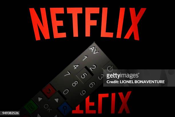This illustration picture taken on April 21, 2018 in Paris shows the logo of the Netflix entertainment company, displayed on a tablet screen with a...