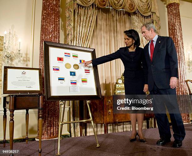President George W. Bush, right, looks on as Condoleezza Rice, U.S. Secretary of state, points to a plaque displaying the countries joining NATO...