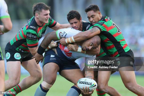 Junior Paulo of the Raiders is tackled by the Rabbitohs defence during the round seven NRL match between the South Sydney Rabbitohs and the Canberra...