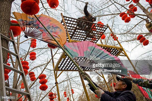 Workers prepare Lunar New Year decorations in Ditan Park in Beijing, China, on Friday, Jan. 16, 2009. Jan. 26 marks the Year of the Ox according to...