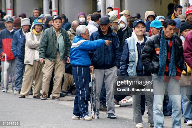 Unemployed men wait in line for jobs outside the Labor Center in Airin, Osaka, Japan, on Thursday, March 5, 2009. Japan's 2.95 million unemployed...