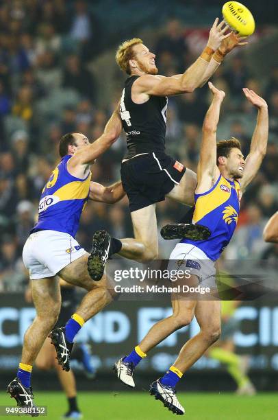 Andrew Phillips of the Blues takes a high mark over Mark Hutchings of the Eagles during the round five AFL match between the Carlton Blues and the...