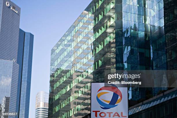 Total SA logo hangs at a gas station in front of the company's headquarters in Paris, France, on Wednesday, Feb. 11, 2009. The company releases its...