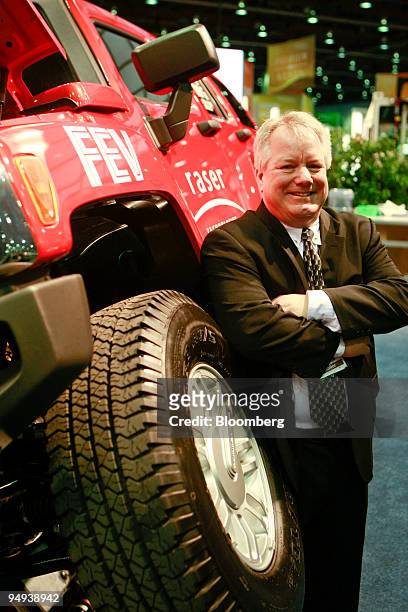 Kraig Higginson, chairman of Raser Technologies, poses with a Hummer H3 during a news conference in Detroit, Michigan, U.S., on Monday, April 20,...