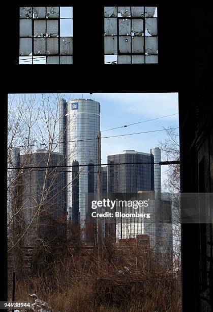 The General Motors Corp. Headquarters is seen through an abandoned building in Detroit, Michigan, U.S., on Tuesday, Feb. 17, 2009. GM and Chrysler...