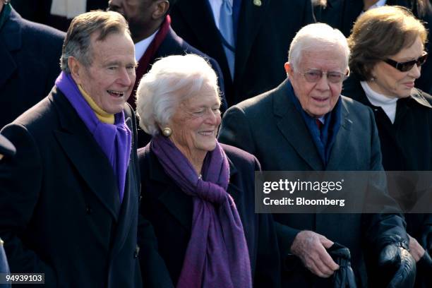 Former U.S. President George H.W. Bush, left, his wife Barbara, center, stand with former President Jimmy Carter as they prepare to depart after the...