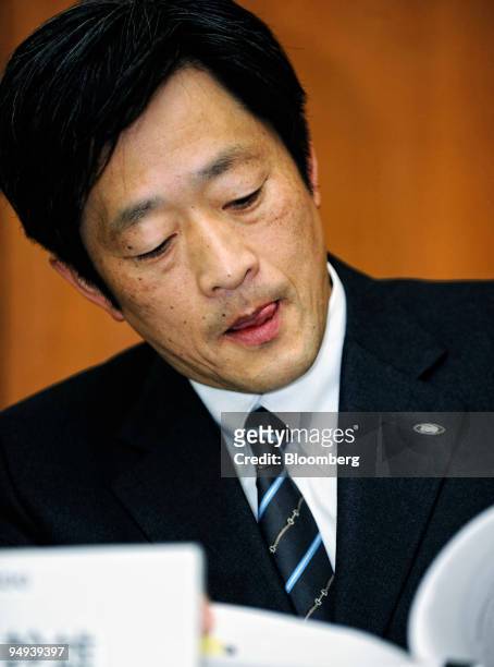 Mikio Katayama, president of Sharp Corp., browses through a company report during a news conference in Tokyo, Japan, on Wednesday, April 8, 2009....