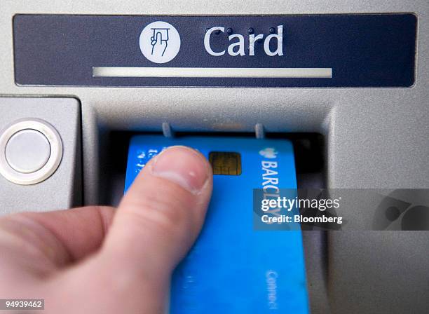 Customer puts a Barclays bank card into a cash machine at a branch of Barclays bank in Romford, Essex, U.K., on Wednesday, Jan. 21, 2009. Barclays...