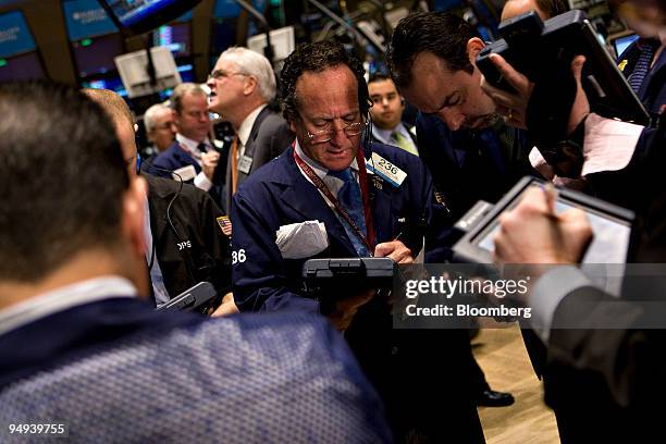 Floor official Steven Kaplan, center, works on the floor of the New York Stock Exchange in New York, U.S., on Monday, April 13, 2009. U.S. Stocks...