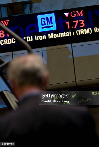 General Motors Corp. Logo and stock price is displayed on a ticker as traders work on the floor of the New York Stock Exchange in New York, U.S., on...