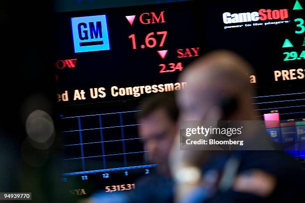 General Motors Corp. Logo and stock price is displayed on a ticker as traders work on the floor of the New York Stock Exchange in New York, U.S., on...