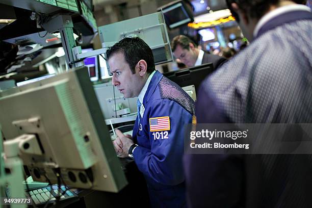 Traders work on the floor of the New York Stock Exchange in New York, U.S., on Monday, April 13, 2009. U.S. Stocks fell, sending the Standard &...