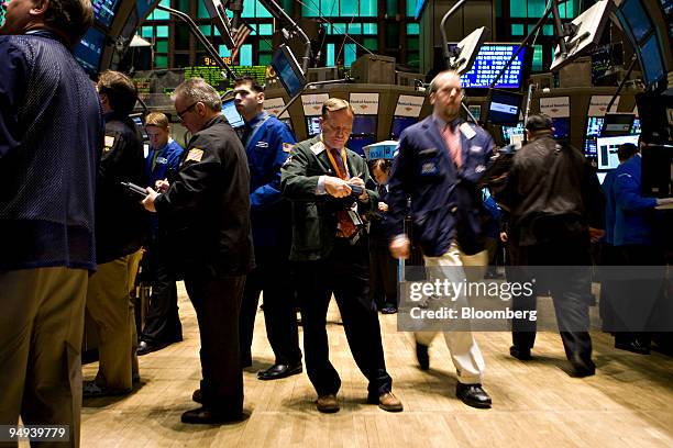 Paul Lawless, center, works on the floor of the New York Stock Exchange in New York, U.S., on Monday, April 13, 2009. U.S. Stocks fell, sending the...