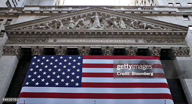 Flag covers the facade of the New York Stock Exchange in New York, U.S., on Monday, April 13, 2009. U.S. Stocks fell, sending the Standard & Poor's...