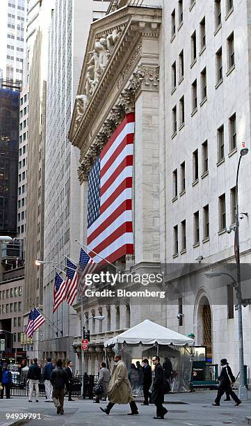 Pedestrians walk outside the New York Stock Exchange in New York, U.S., on Monday, April 13, 2009. U.S. Stocks fell, sending the Standard & Poor's...
