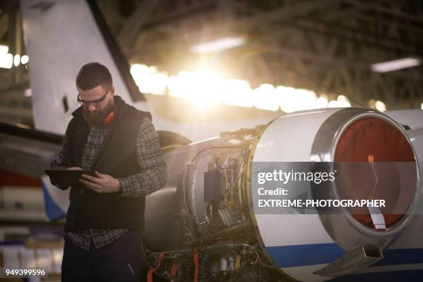 aircraft mechanic in the hangar - aircraft maintenance stock pictures, royalty-free photos & images