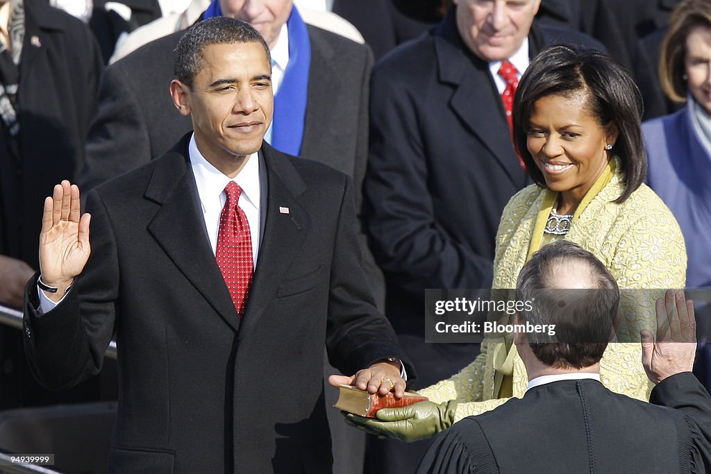 U.S. President Barack Obama, left, is sworn in as wife Miche