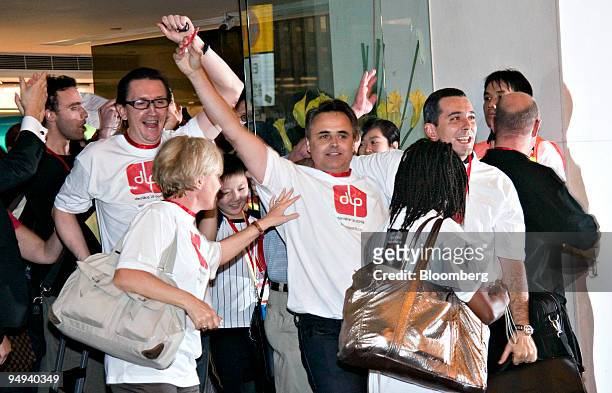 Guests and staff of the Metropark Hotel cheer as they are released from quarantine in Hong Kong, China, on Friday, May 8, 2009. 286 guests and staff...