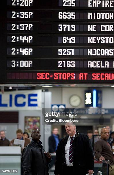 Riders look up at the departure board at Pennsylvania Station in New York, U.S. On Wednesday, March 25, 2009. International Business Machines Corp.,...